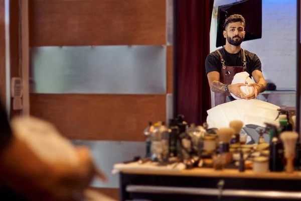 Master cuts hair and beard of men in the barbershop, hairdresser makes hairstyle for a young man. Work in the Barber shop, The process of the hairdresser.