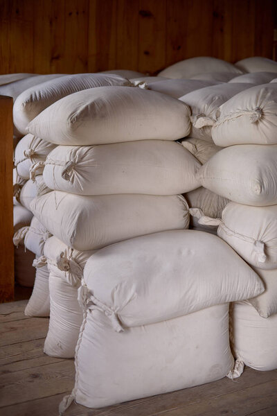 The full bags in an old barn, sacks of flour on in warehouse