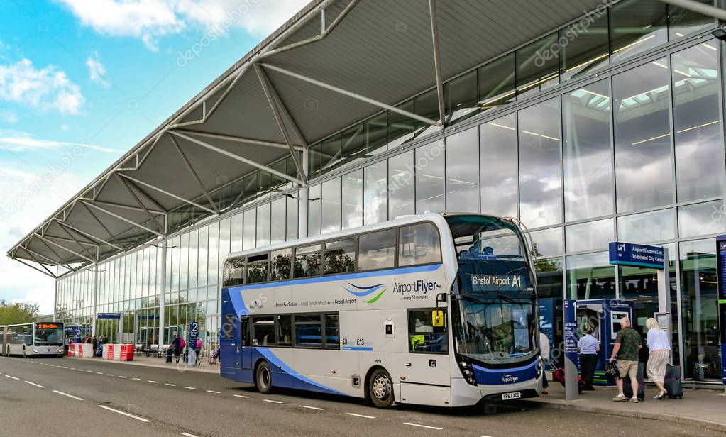 BRISTOL, ENGLAND - AUGUST 2019: Airport Flyer bus at a bus stop outside the terminal building at Bristol Airport. It is a shuttle service linking the airport and the city centre.