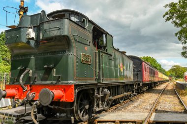 Cranmore, İngiltere - Temmuz 2019: Doğu Somerset Demiryolu'ndaki Cramore İstasyonu'ndan kalkmayı bekleyen vagonların buharlı motoru ve treni.