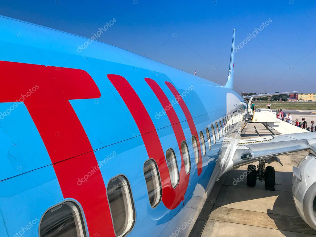 NAPLES, ITALY - AUGUST 2019:  TUI logo on the side of a Boeing 737 holiday jet at Naples airport.