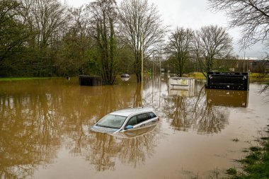 NANTGARW, NEAR CARDIFF, WALES - FEBRUARY 2020: Car submerged in storm water after the River Taff burst its banks near Cardiff. clipart