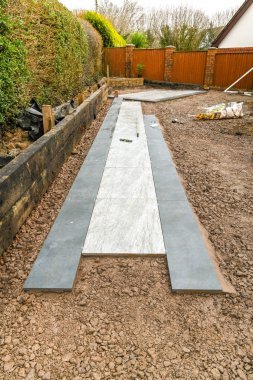 CARDIFF, WALES - FEBRUARY 2020: Path of porcelain slabs being laid in the garden of a residential property