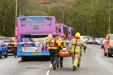 NANTGARW, NEAR CARDIFF, WALES - FEBRUARY 2020: Firemen carrrying an elderly lady on a stretcher after evacuation due to flooding in Nantgarw near Cardiff
