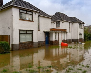 TREFOREST, NEAR CARDIFF, WALES - FEBRUARY 2020: Flooded garden of a house in Treforest after the River Taff burst its banks after rain from Storm Dennis.