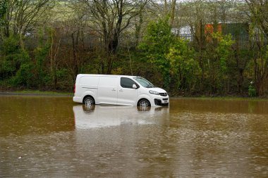TREFOREST INDUSTRIAL ESTATE, NEAR CARDIFF, WALES - FEBRUARY 2020: Van stuck in a flooded car park on Treforest Industrial Estate near Cardiff