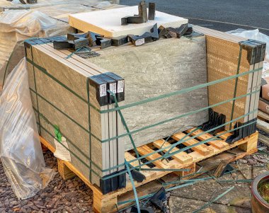 CARDIFF, WALES - JANUARY 2020: Wooden pallet of heavy porcelain paving slabs for a patio.