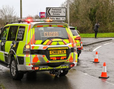 NANTGARW, NEAR CARDIFF, WALES - FEBRUARY 2020: Two traffic officer patrol vehicles blocking a road due to flooding in Nantgarw near Cardiff