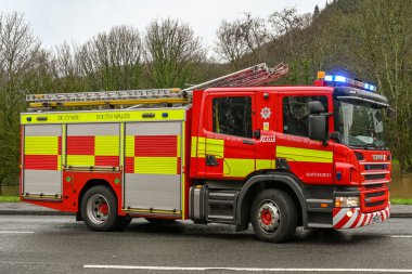 NANTGARW, NEAR CARDIFF, WALES - FEBRUARY 2020: South Wales Fire and rescue service fire tender with blue lights flashing at an incident in Nantgarw near Cardiff