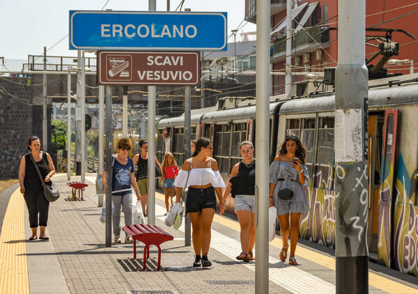 ERCOLANO, NEAR NAPLES, ITALY - AUGUST 2019: People arriving at Ercolano railway station on the outskirts of Naples.