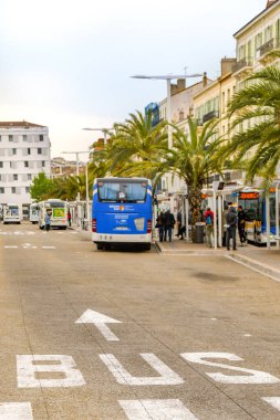 CANNES, FRANCE - APRIL 2019: Buses waiting at bus stops outside the railway station in the centre of Cannes.