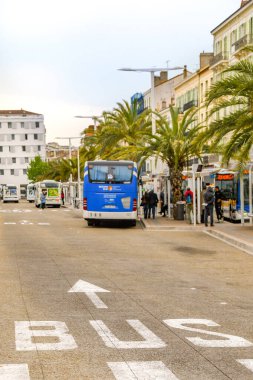 CANNES, FRANCE - APRIL 2019: Buses waiting at bus stops outside the railway station in the centre of Cannes.