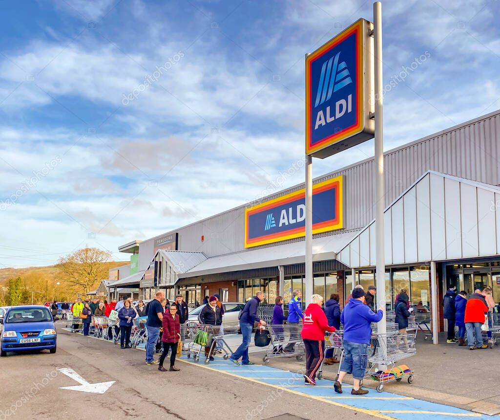 PONTYPRIDD, WALES - 21 MARCH 2020: People queuing to shop in an ALDI store in Pontypridd as worry about the impact of the coronavirus outbreak increases.
