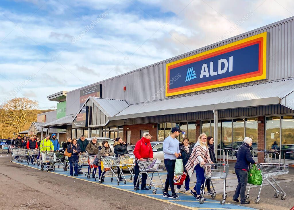 PONTYPRIDD, WALES - 21 MARCH 2020: People queuing to shop in an ALDI store in Pontypridd as worry about the impact of the coronavirus outbreak increases.