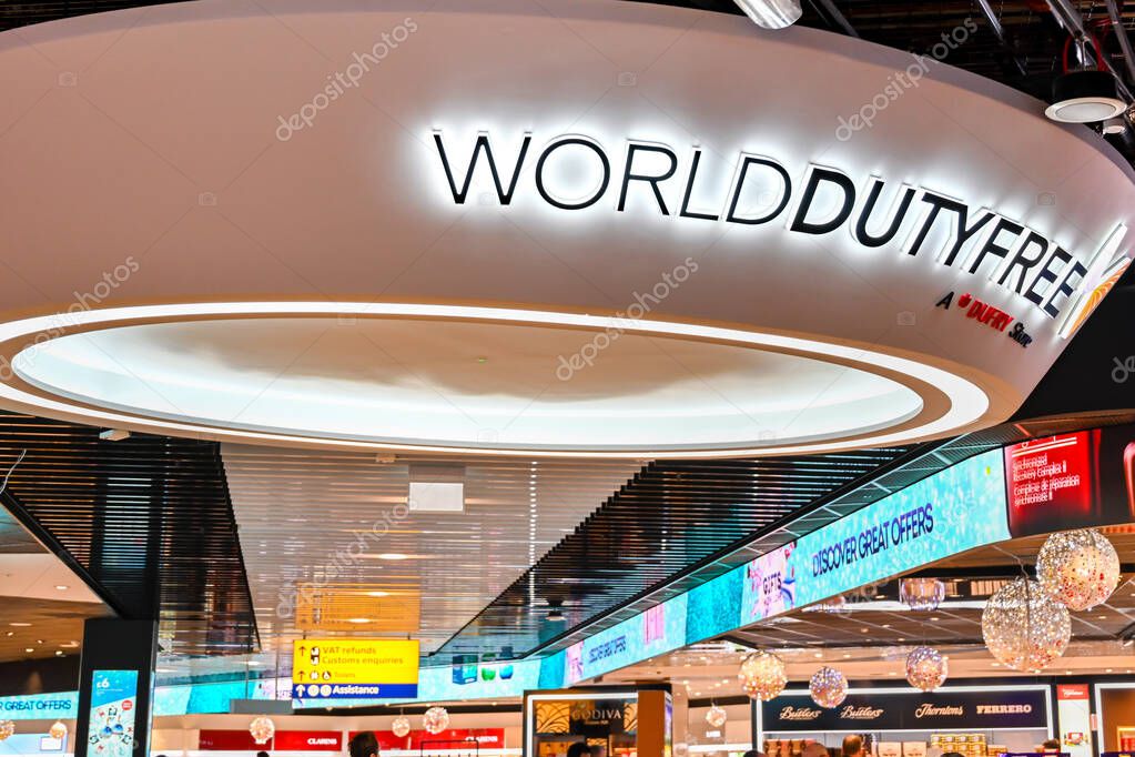 LONDON HEATHROW AIRPORT, ENGLAND - NOVEMBER 2019: Illuminated sign above the World Duty Free shop in Terminal 3 of London Heathrow Airport. It is part of the worldwide chain of stores owned by Dufry.