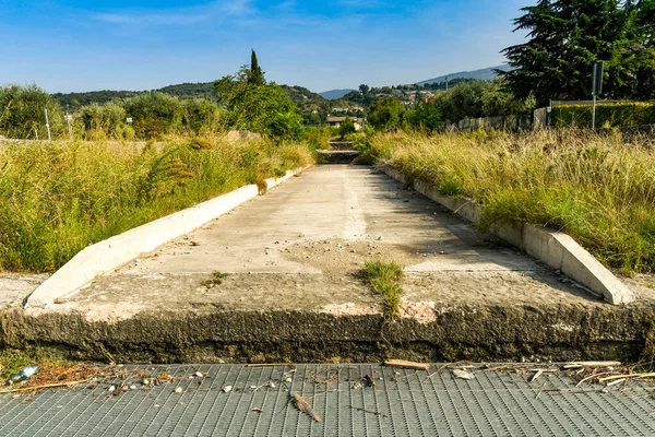 Concrete water channel and storm drain to prevent flooding after a storm.