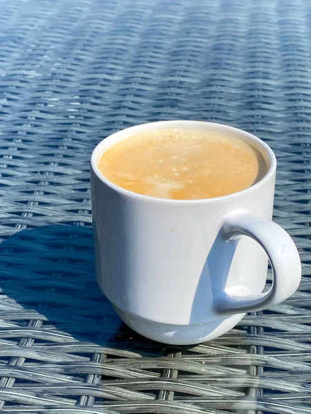 Biały Kubek Gorącą Piankową Kawą Szklanym Stole Mebli Ogrodowych — Zdjęcie stockowe