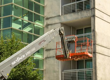 Cardiff Körfezi 'ndeki bir apartmanın dışını temizlemek için hidrolik kaldırma platformu 