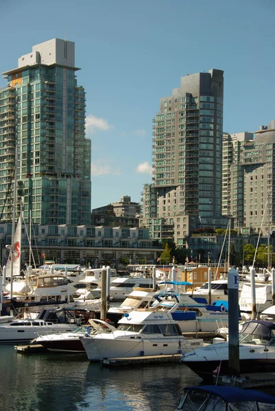 Vancouver, Kanada - Eylül 2012: Vancouver limanında arka planda deniz kenarındaki apartman blokları bulunan tekneler