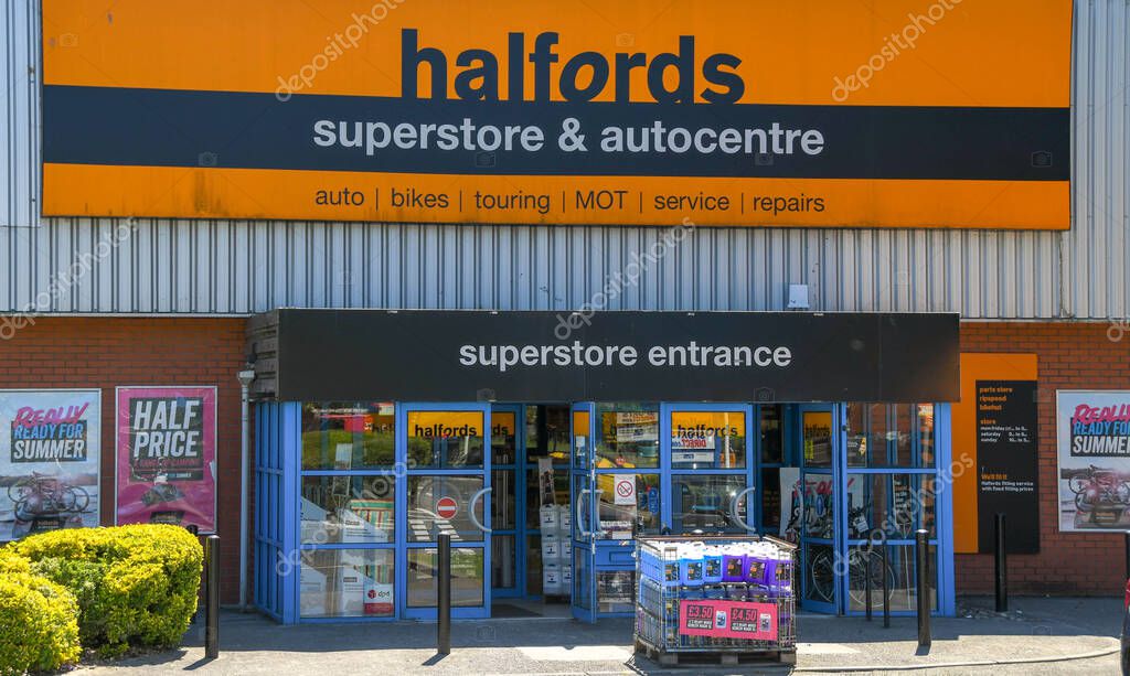 PONTYPRIDD, WALES - JUNE 2018: Large sign above the entrance to a Halfords superstore near Pontyrpidd town centre