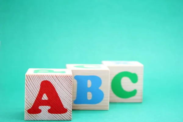 English ABC letters on wooden toy blocks. letters of the English alphabet. Learn foreign languages. English for beginners. Copy space.