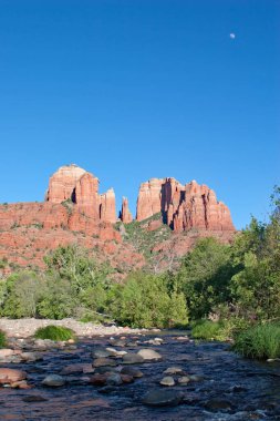 Cathedral Rock and Oak Creek amidst green summer foliage near Sedona, Arizona.