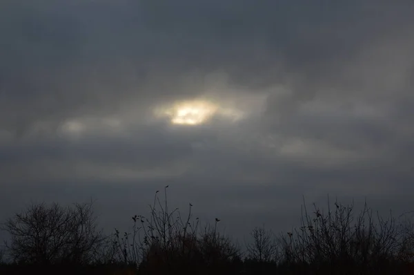 The sun breaks through the clouds in the sky