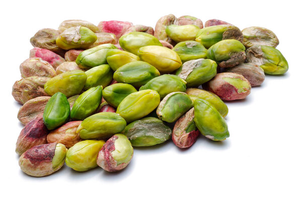 Heap of peeled pistachio nuts isolated