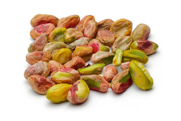 Heap of peeled pistachio nuts isolated on white background