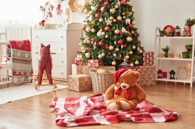 Çocukların yatak odasının içi. Çocuk oyun odasında yılbaşı süsü ve ağaç. Noel tarzı bir çatı katı. Noel 'i çocuk odasında geçireceğiz. Noel ağacının arka planında yumuşak oyuncak ayı