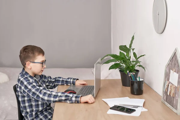 Online lesson at home, social distance during quarantine, self-isolation, online education concept, home schooler. Boy learning language online, using laptop, distance education. Student boy, school.