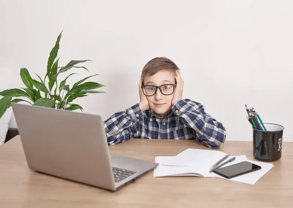 Online lesson at home, social distance during quarantine, self-isolation, online education concept, home schooler. Boy learning language online, using laptop, distance education. Student boy, school.