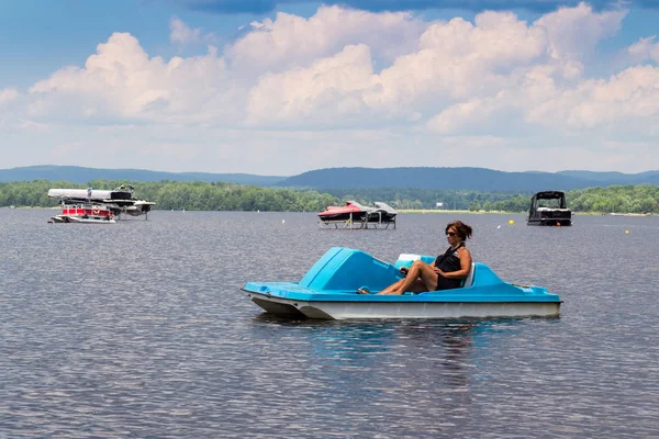 Adult woman on a pedal boat alone — Stock Photo, Image