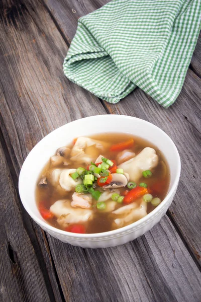 Dumpling soup with green onion on wood table — Stock Photo, Image
