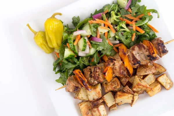Pork kebab skewer dish with potatoes and salad — Stock Photo, Image