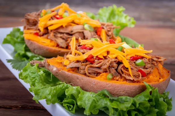 Delicious spicy pulled pork stuffed sweet potato dish — Stock Photo, Image