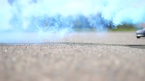 A small car rides in the smoke. Beautiful frames in the smoke. A lot of smoke — Stock Video
