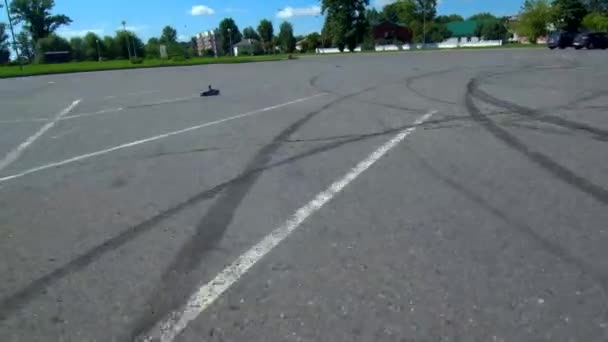 Une petite voiture roule sur l'asphalte en été . — Video