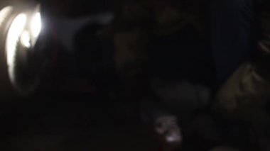 Çocuklar bir araba tamirhanesinde tamirat yapıyor..