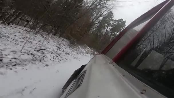 Ein altes Auto treibt auf einer schneebedeckten Straße. Winter. Viel Schnee. — Stockvideo