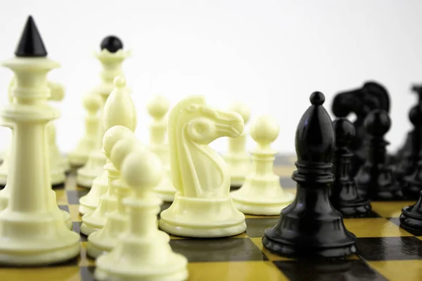 Piezas de ajedrez blanco de pie en un tablero de ajedrez durante una partida de ajedrez, se centran en el centro del tablero — Foto de Stock