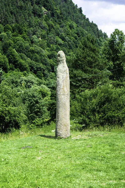 Stone idol of the 8th century on a background of green forest, Arkhyz, Karachay-Cherkessia, Russia
