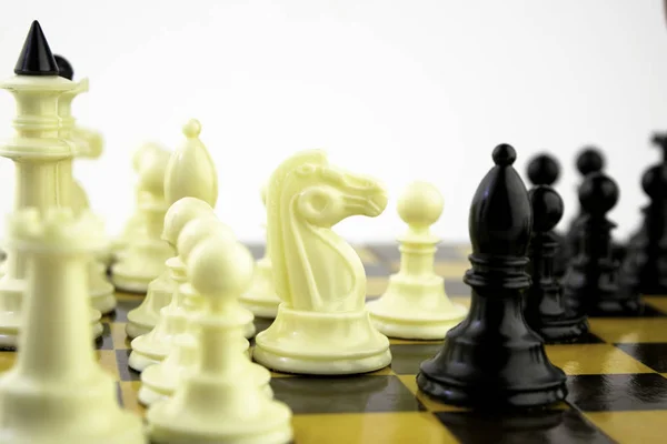 Vita schackpjäser står på ett schackbräde under ett schackspel, fokus i mitten av brädet — Stockfoto