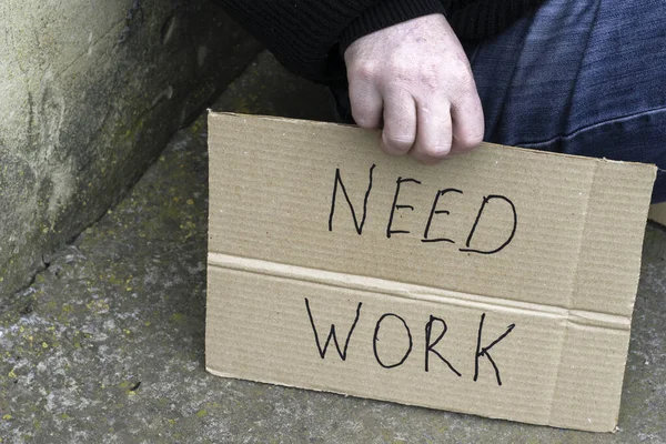 Unemployed Man Sitting Ground Holding Cardboard Sign Saying Need Work — Stock Photo, Image