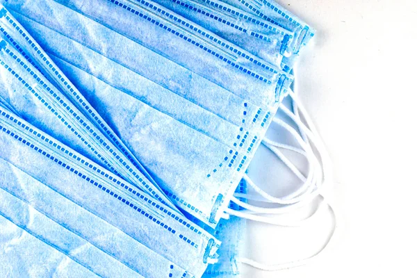 stack of medical hygiene masks on a white background close-up