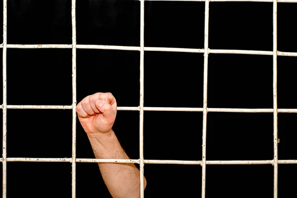 Concept of limitation in the era of the quarantine pandemic human hand hold on to a iron bars — Stock Photo, Image