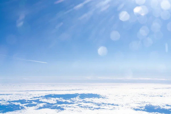 Flight over the clouds with blue sky and sunshine