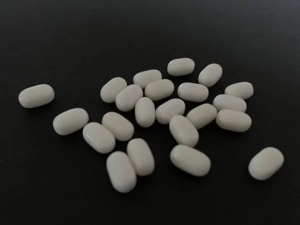 Tablets and pills on dark background — Stock Photo, Image