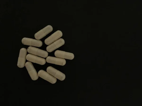 Tablets and pills on dark background — Stock Photo, Image