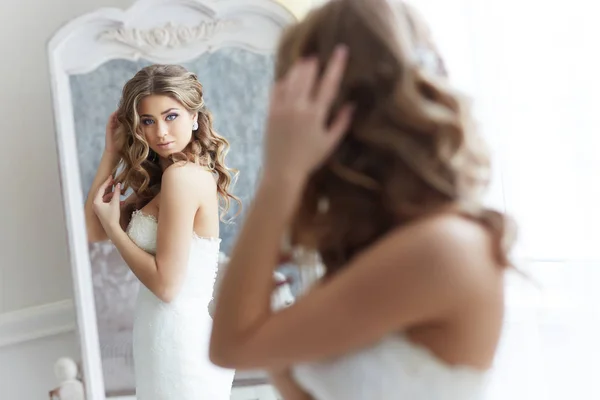 beautiful bride looking in mirror